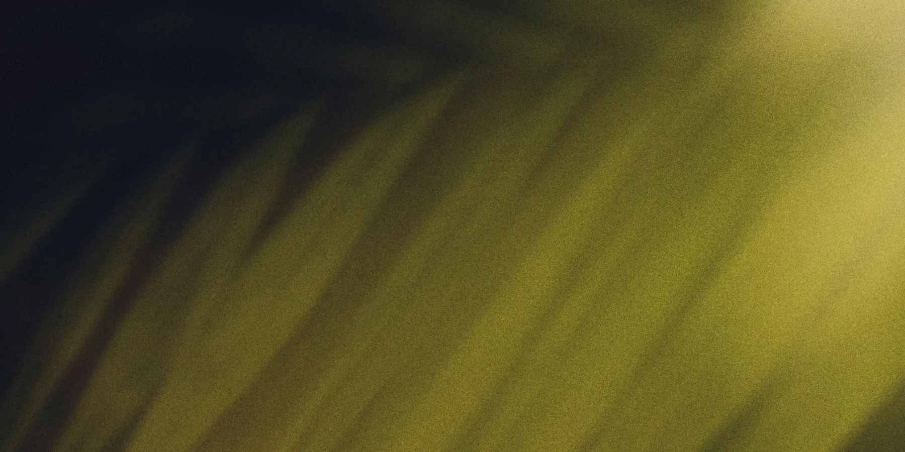 Soft-focus botanical forms in deep green and warm gold